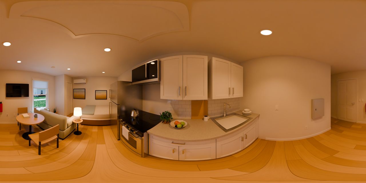 White shaker cabinets and a stainless sink, with the range and refrigerator beside them and a microwave over the range. A fruit bowl, a mug, a cutting board and a pot of herbs sit on the counter, with plates and a bowl beside the sink.