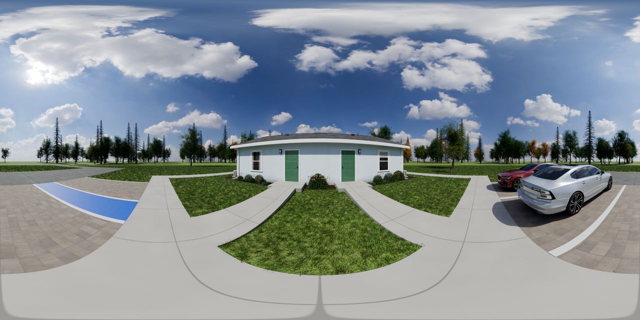 The one-story 4-plex from its entry walk, with studio doors along the side and parking nearby.